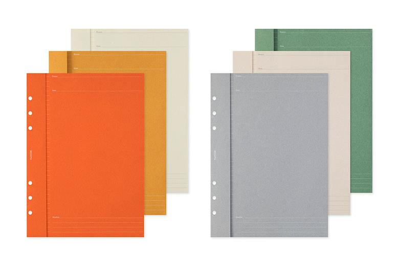 Six A5 plastic folder refills in assorted colors shown in two groups, displaying punched holes.