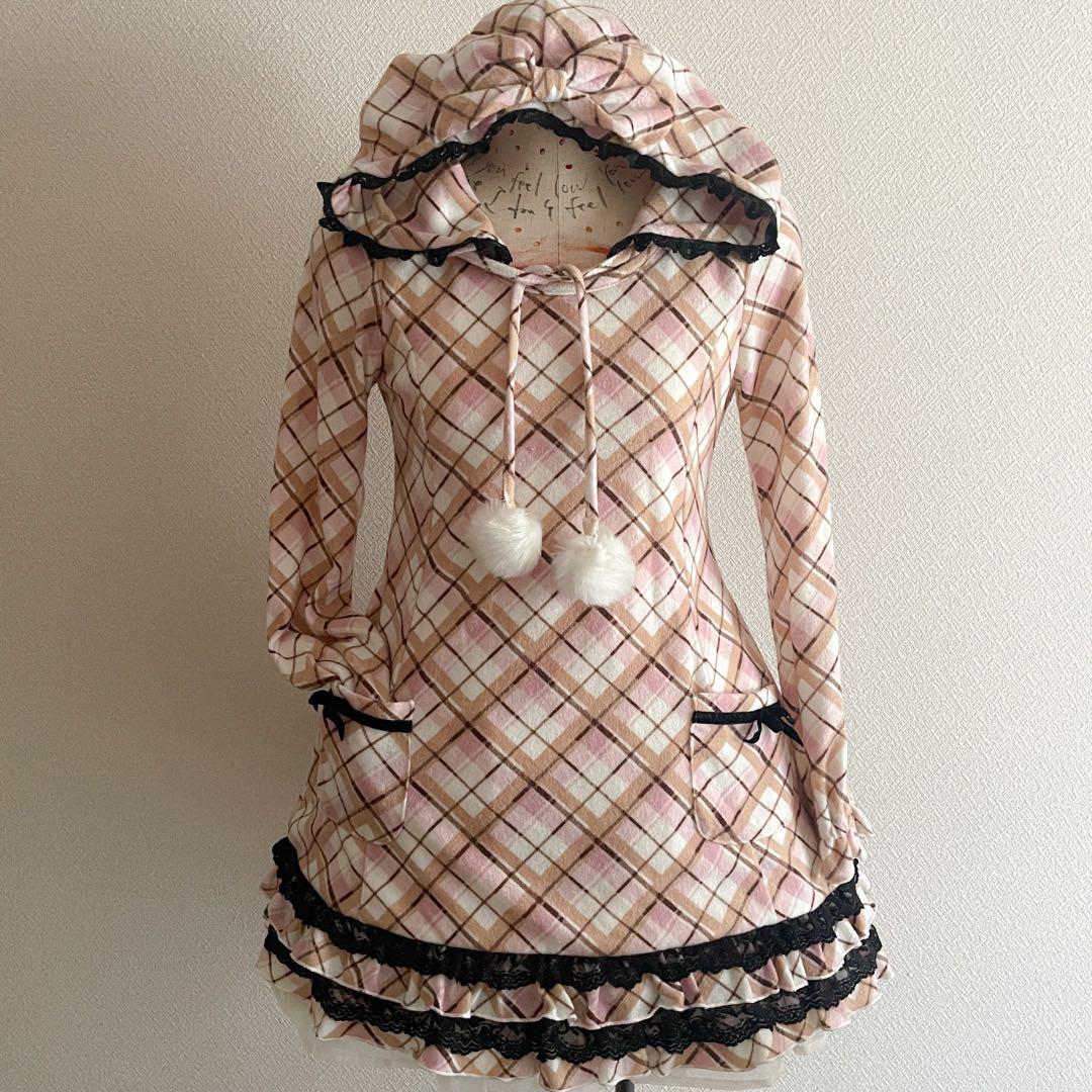 Front view of the 00s TRALALA check-patterned brushed mini dress with a hood, large bow, pom-pom ties, and ruffled black-lace trimmed hem on a mannequin.