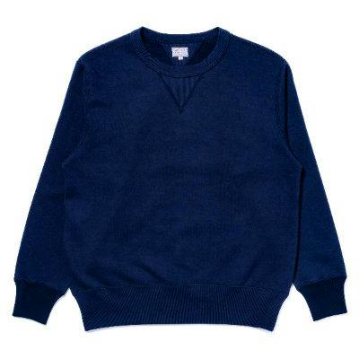 Men's navy crewneck sweatshirt laid flat showing ribbed cuffs and hem and a V-stitch at the collar.