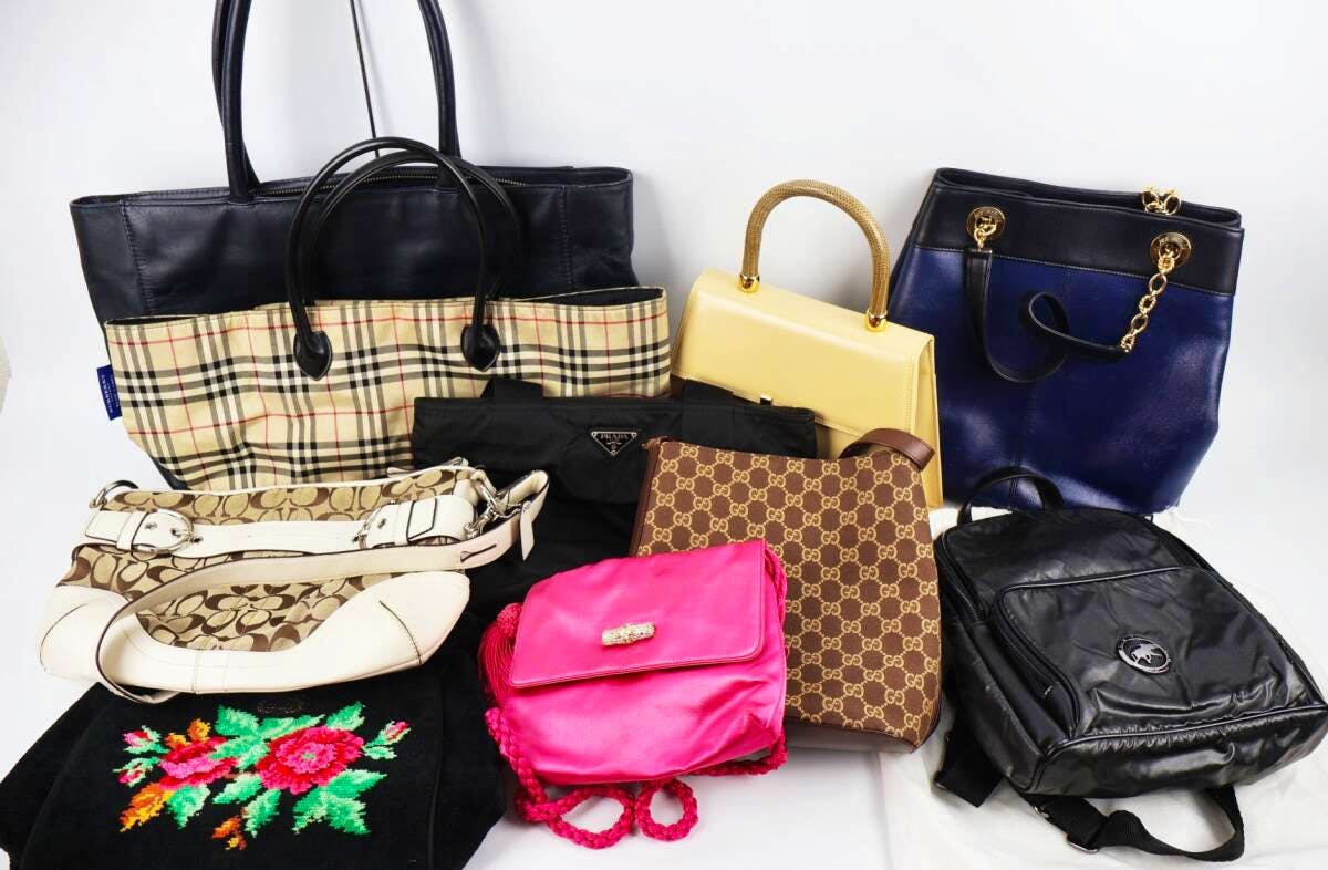 Ten assorted bags, including leather and patterned styles, arranged on a white background.