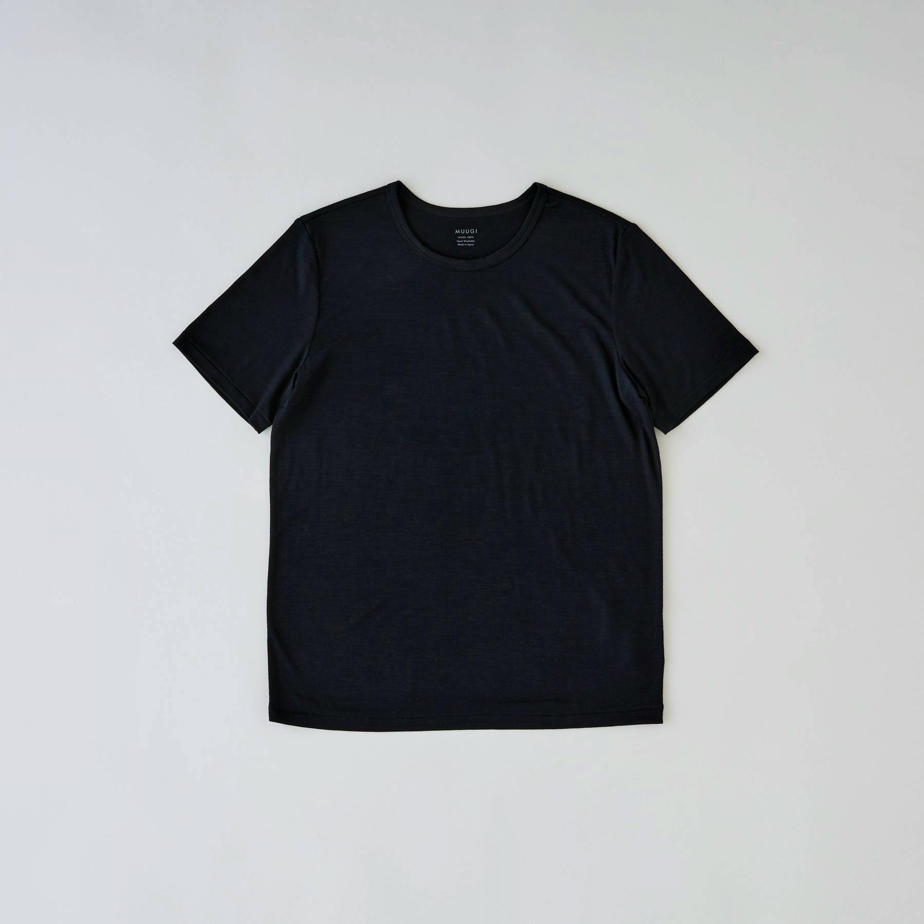 Flat-lay of a black 100% merino wool crew-neck short-sleeve tee on a light background.