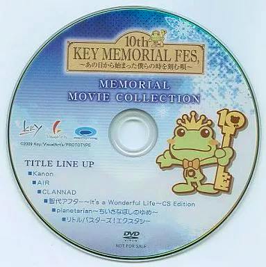 Photo of the DVD disc face for "10th KEY MEMORIAL FES ～MEMORIAL MOVIE COLLECTION" showing the printed title and a cartoon frog character holding a key.