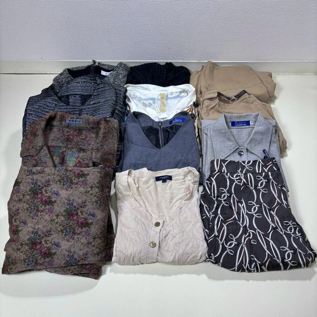 Folded women's garments, including skirts and tops, arranged on a flat surface.
