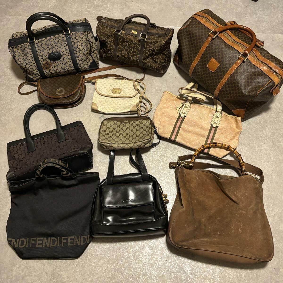 Eleven assorted branded handbags and totes (including Gucci and Fendi styles) arranged on a floor.
