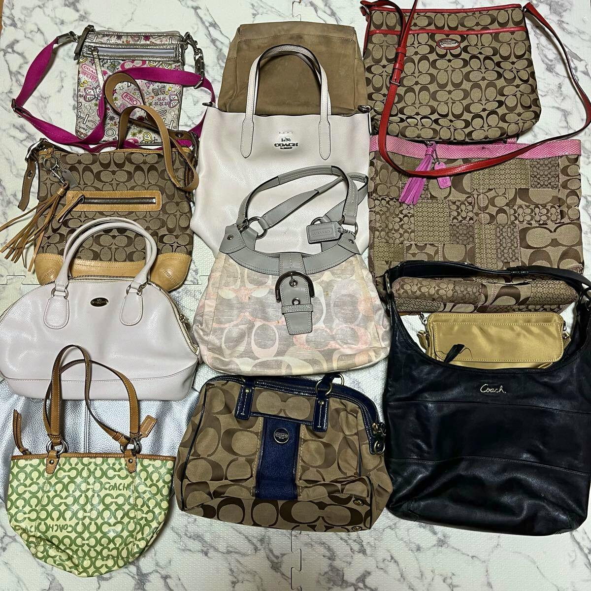Top-down photo of a laid-out assortment of Coach bags and purses, showing various canvas and leather styles from the 13-piece set.