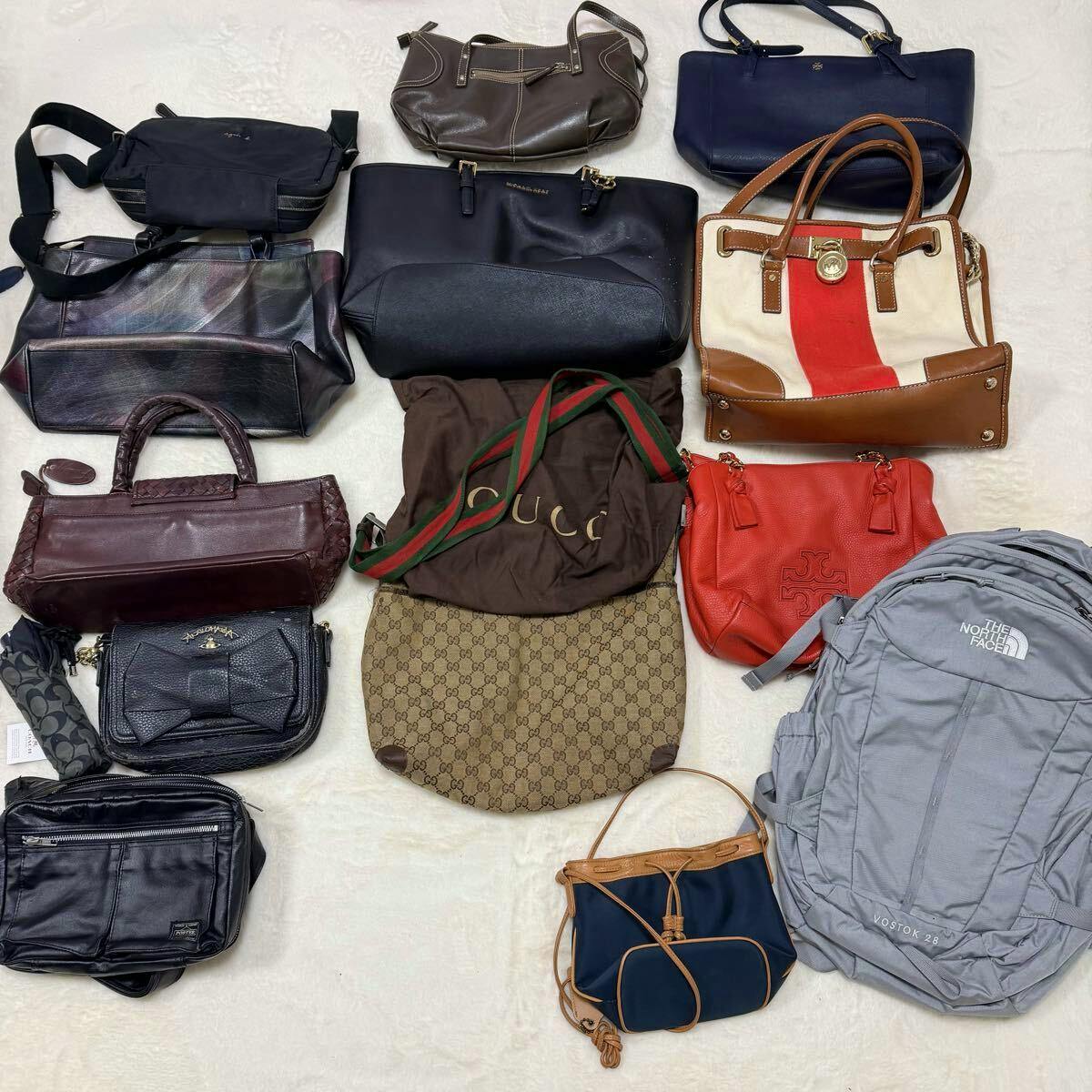 Overhead view of a bulk set of branded handbags and accessories arranged on a light background.