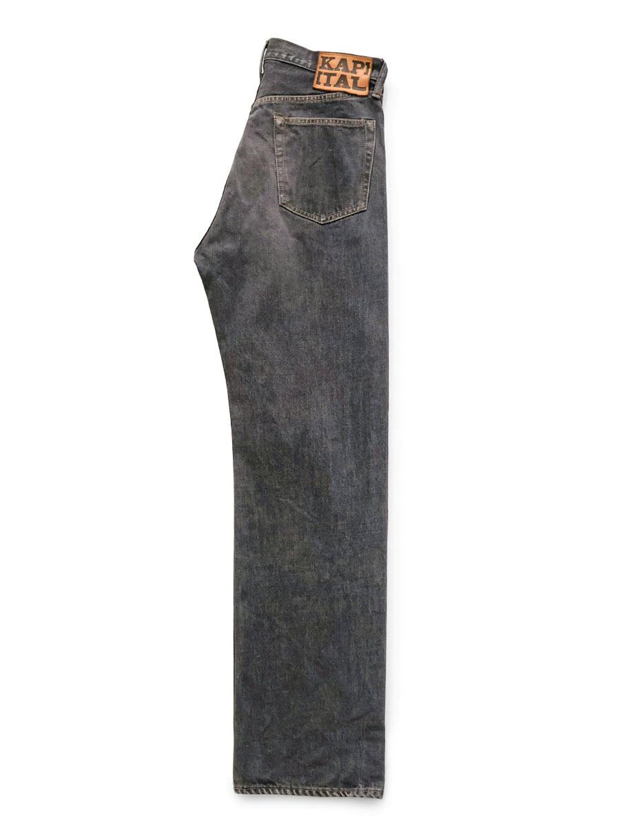 Side flat-lay photo of black men's 5-pocket denim jeans showing the leg, back pocket, and leather brand patch at the waistband.