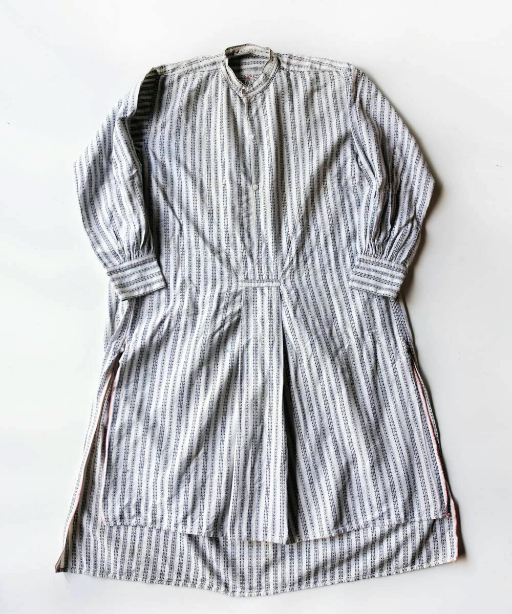 Laid-flat vintage striped smock shirt with long sleeves, a band collar, central pleat, and side slits on a white background.