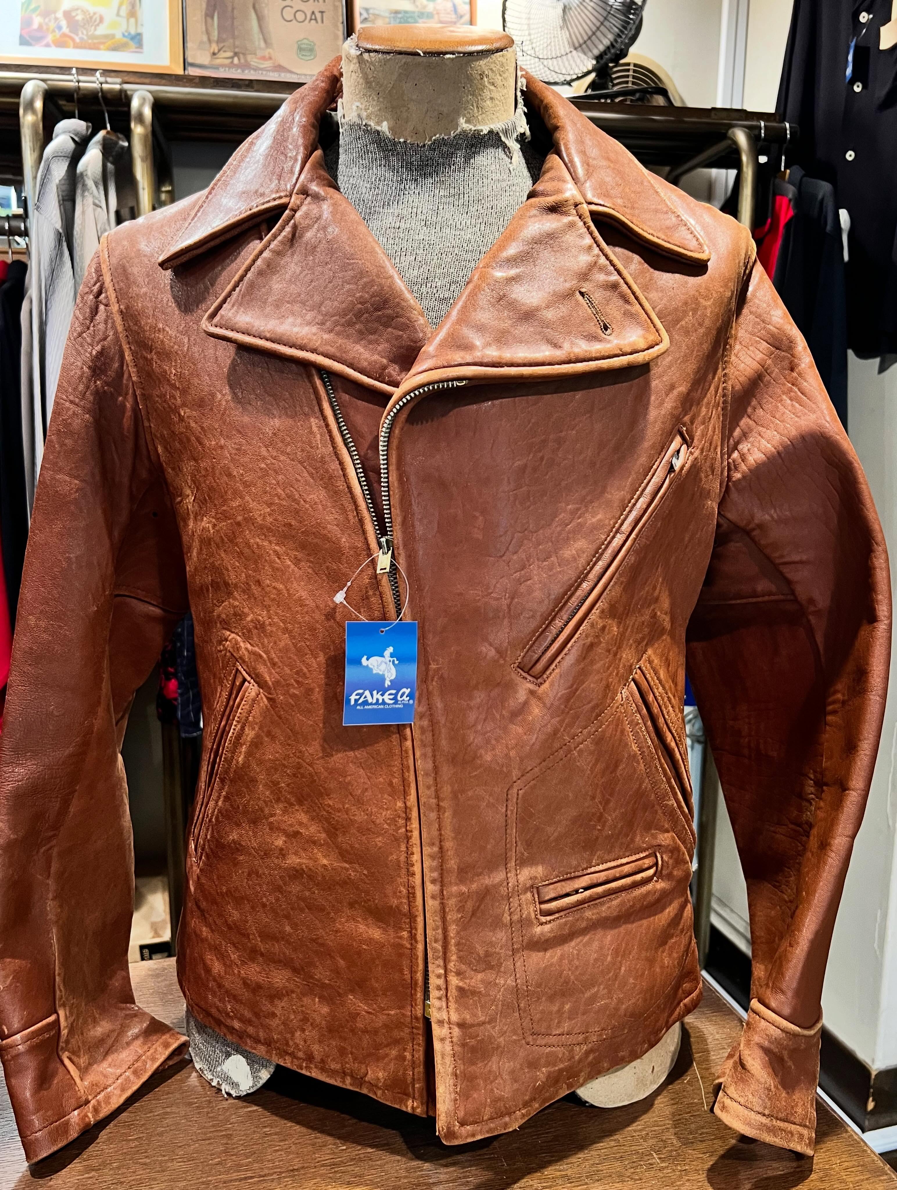 Brown 1940s men's cow leather jacket displayed on a mannequin.