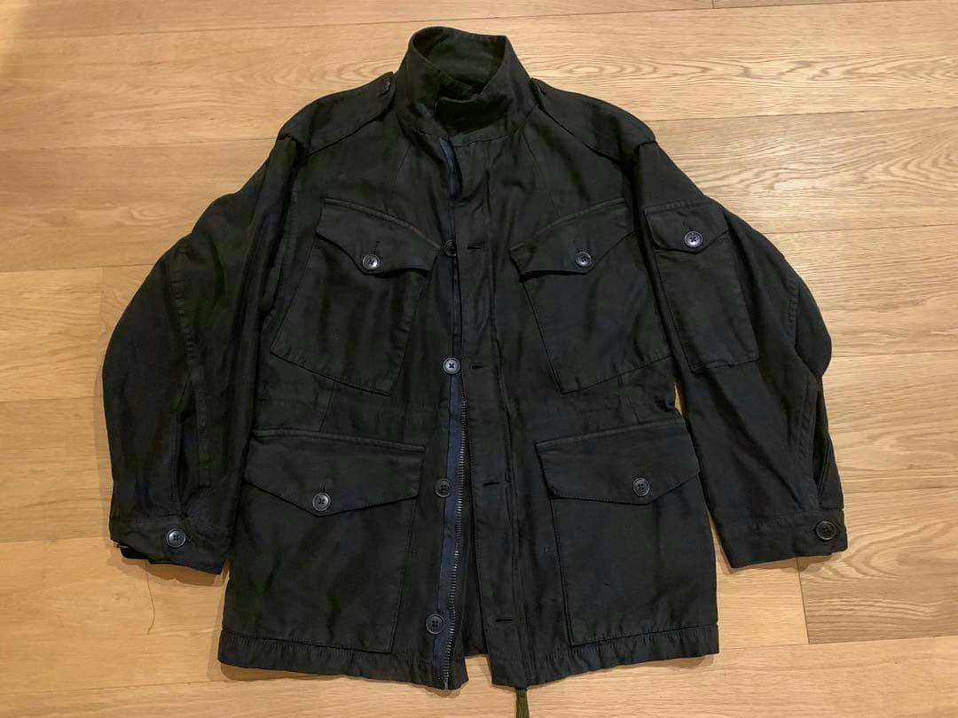 Front view of the British Army P68 combat smock jacket laid flat on a wooden floor.