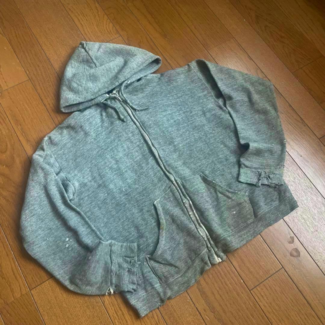 60s gray cotton zip-up hooded sweatshirt laid flat showing the front with zipper, pockets, and visible worn areas.