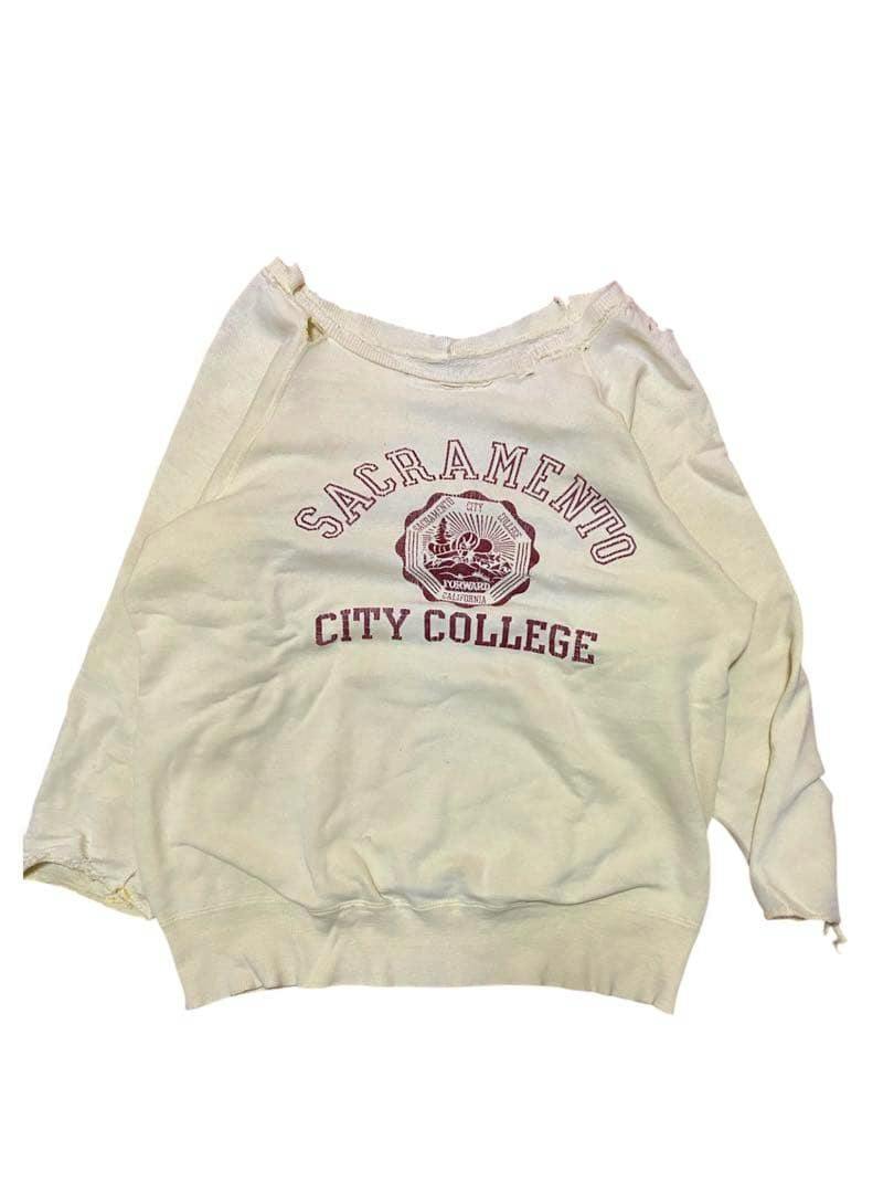 Cream men's cotton sweatshirt with "SACRAMENTO CITY COLLEGE" and a crest printed on the front, showing wear and small tears.