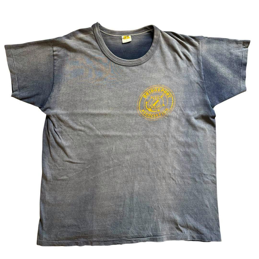 Front view of a faded navy 1970s Russell Athletic vintage men's cotton T-shirt with a small yellow circular chest print.