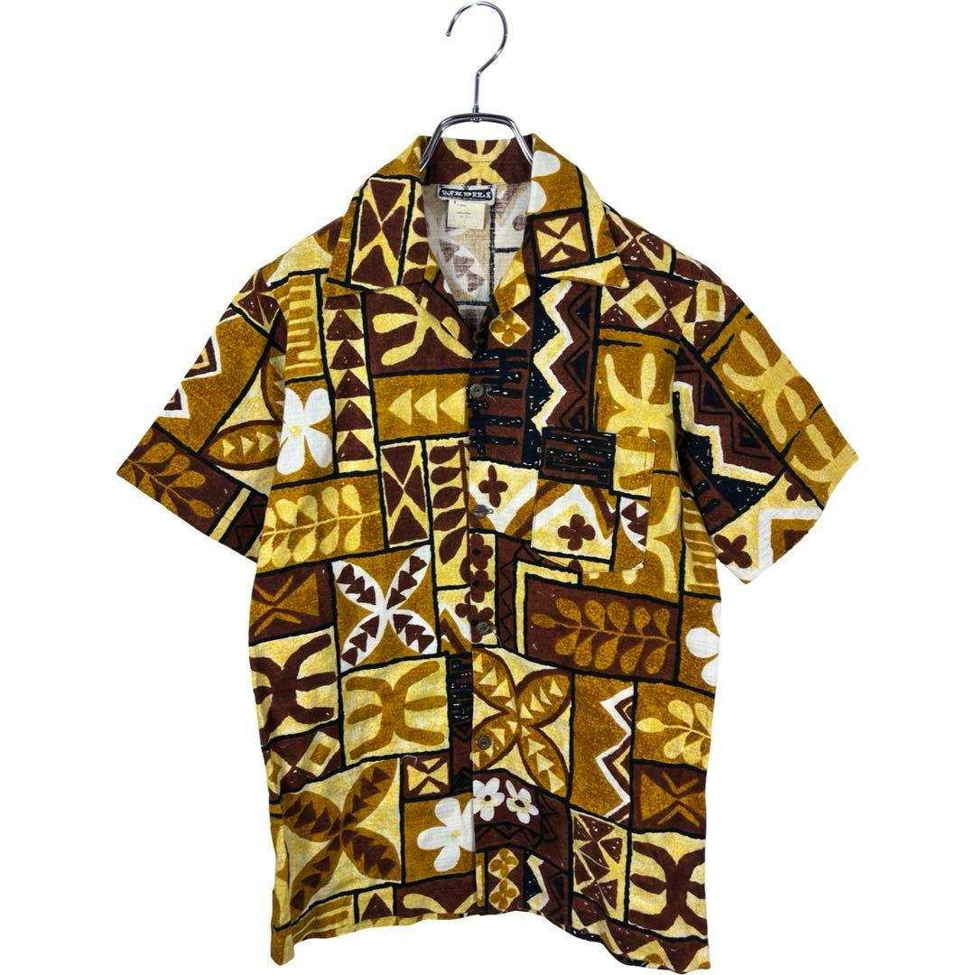 Front view of a vintage 70s Napili pullover cotton Aloha shirt with brown, yellow, and white geometric and floral pattern hanging on a hanger.