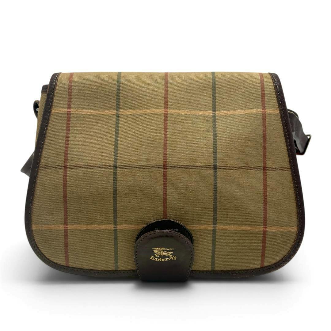 Front view of a Burberrys shoulder bag in Haymarket check with brown leather trim and flap closure.