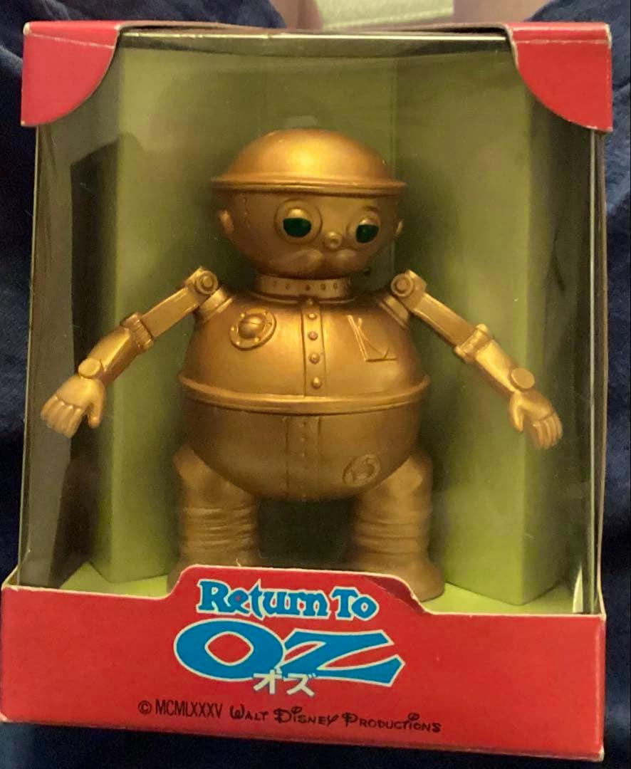 Front view of the gold Tik-Tok figure from Return to Oz displayed in its red window box.