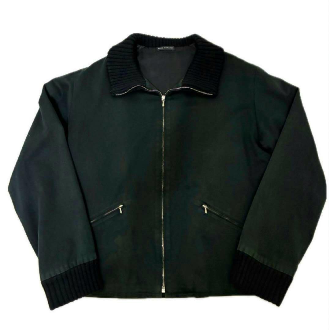 Black men's cotton zip-up agnes b homme jacket with ribbed collar and cuffs laid flat on a white background.