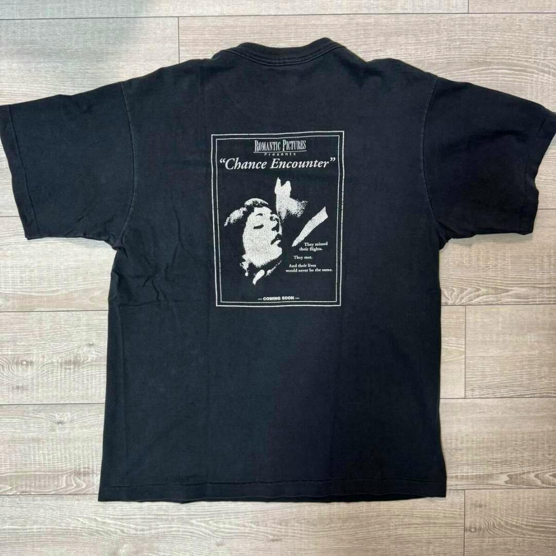 Black cotton T-shirt laid flat showing the back with a centered white "Chance Encounter" movie-style print.