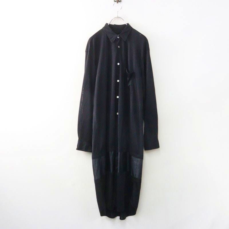 Black long-sleeve women's rayon dress (Comme des Garçons) hanging on a hanger against a white background.