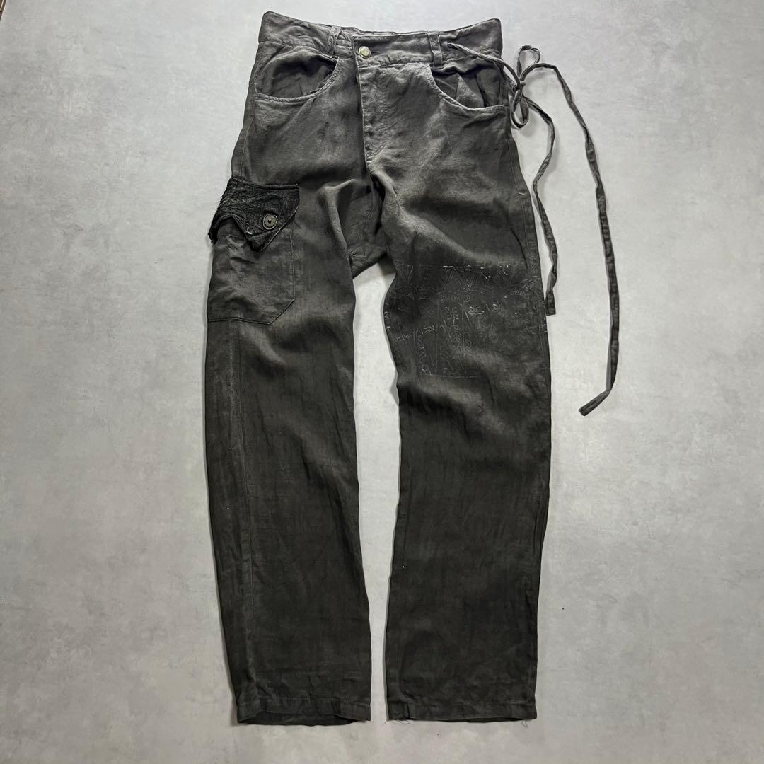 Flat-lay photo of the linen deerskin cargo pants laid flat on a light surface showing full length and side tie.