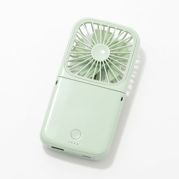 Shiny light green smart handheld fan lying flat showing front with circular blades and power button.