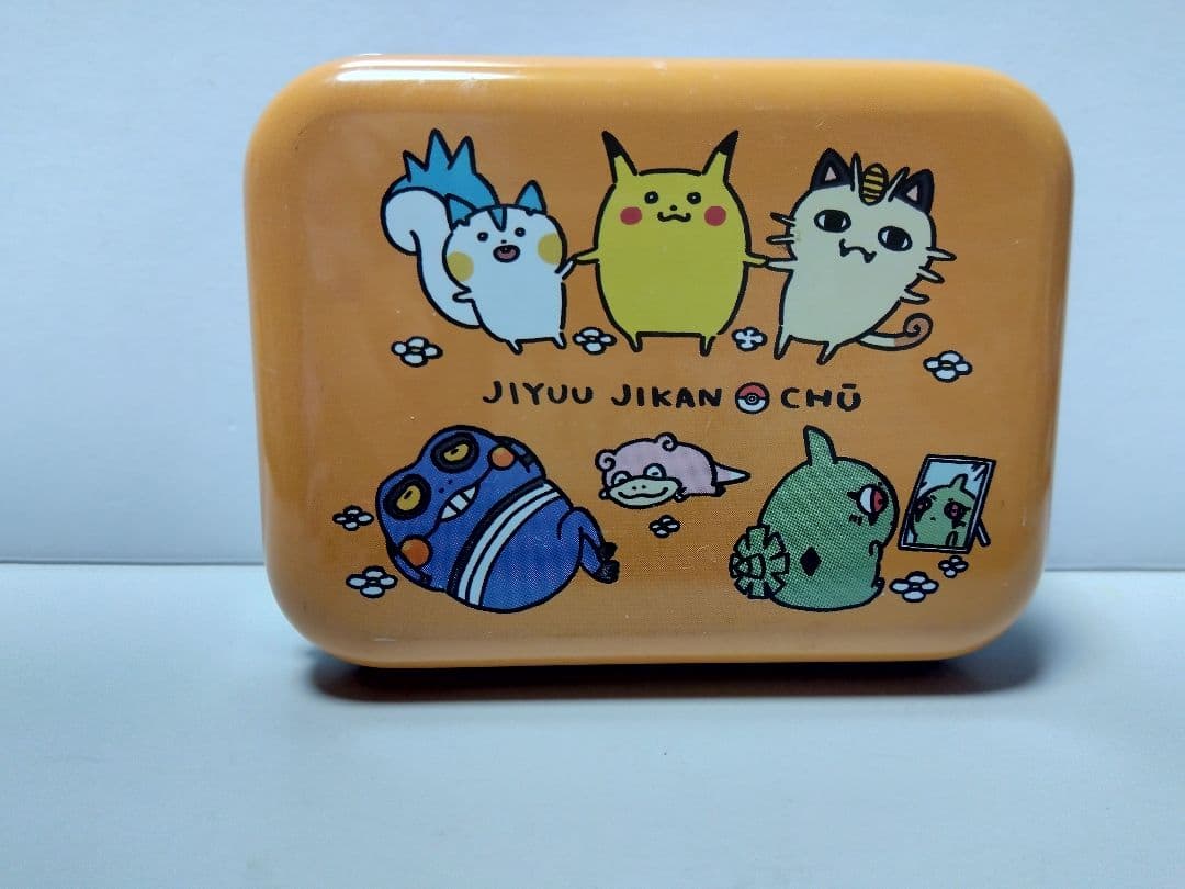 Square aluminum tin can with an orange top showing stylized Pokémon characters and the text "JIYUU JIKAN CHU".