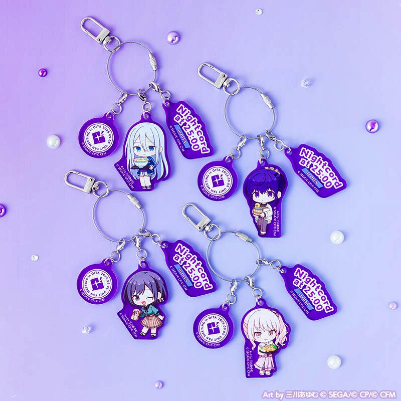 Photo of the acrylic charm set showing four purple keychain charms with chibi character designs plus round and "Nightcord at 25:00" tag charms on a purple background.