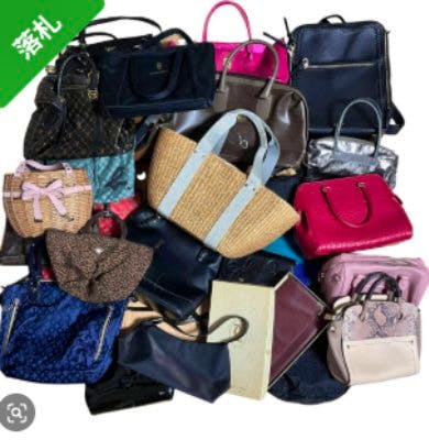 A group of assorted handbags and small bags arranged together against a white background.
