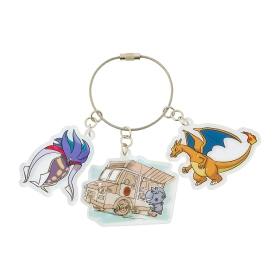 A metal keyring with three attached acrylic charms showing illustrated characters and a small illustrated truck.