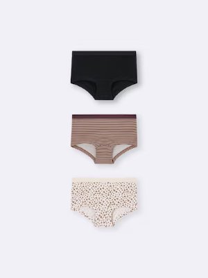 Three boxer shorts displayed vertically on a white background: a black pair, a brown striped pair, and a cream pair with small scattered dots.
