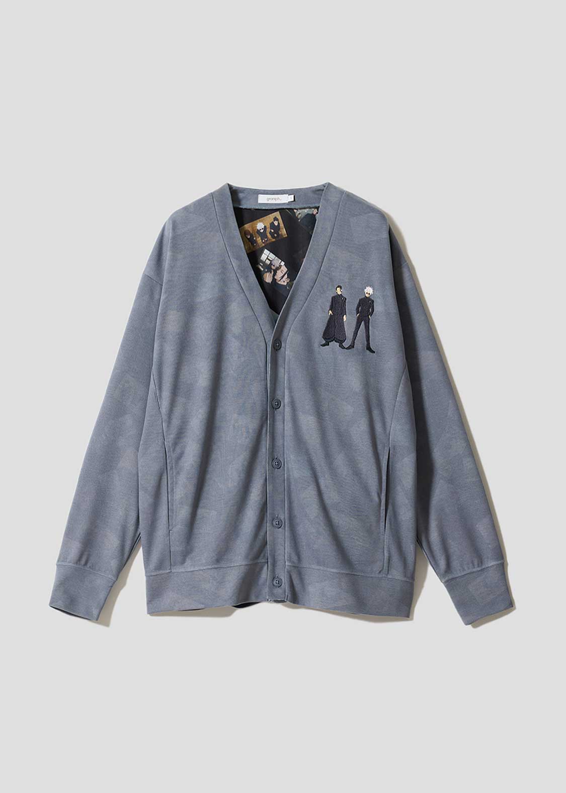 Front view of the cardigan laid flat showing a button-up V-neck and small embroidered character motifs on the left chest.