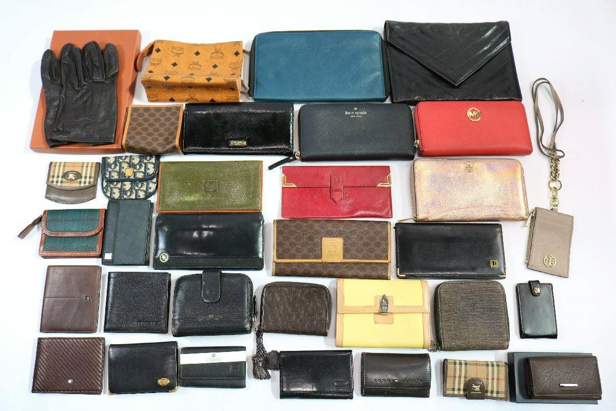Multiple wallets, coin purses, card cases and small accessories arranged on a white background.