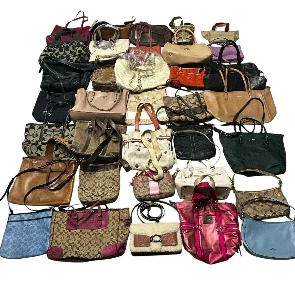 A large assortment of Coach handbags and totes arranged together on a white background representing a bulk set.