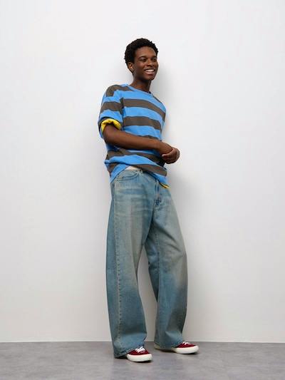 Male model wearing the men's 3D Barrel Jeans in a light wash, standing against a white background.