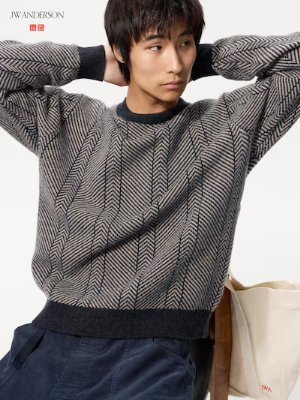 Male model wearing a patterned wool sweater with long sleeves and a ribbed hem.