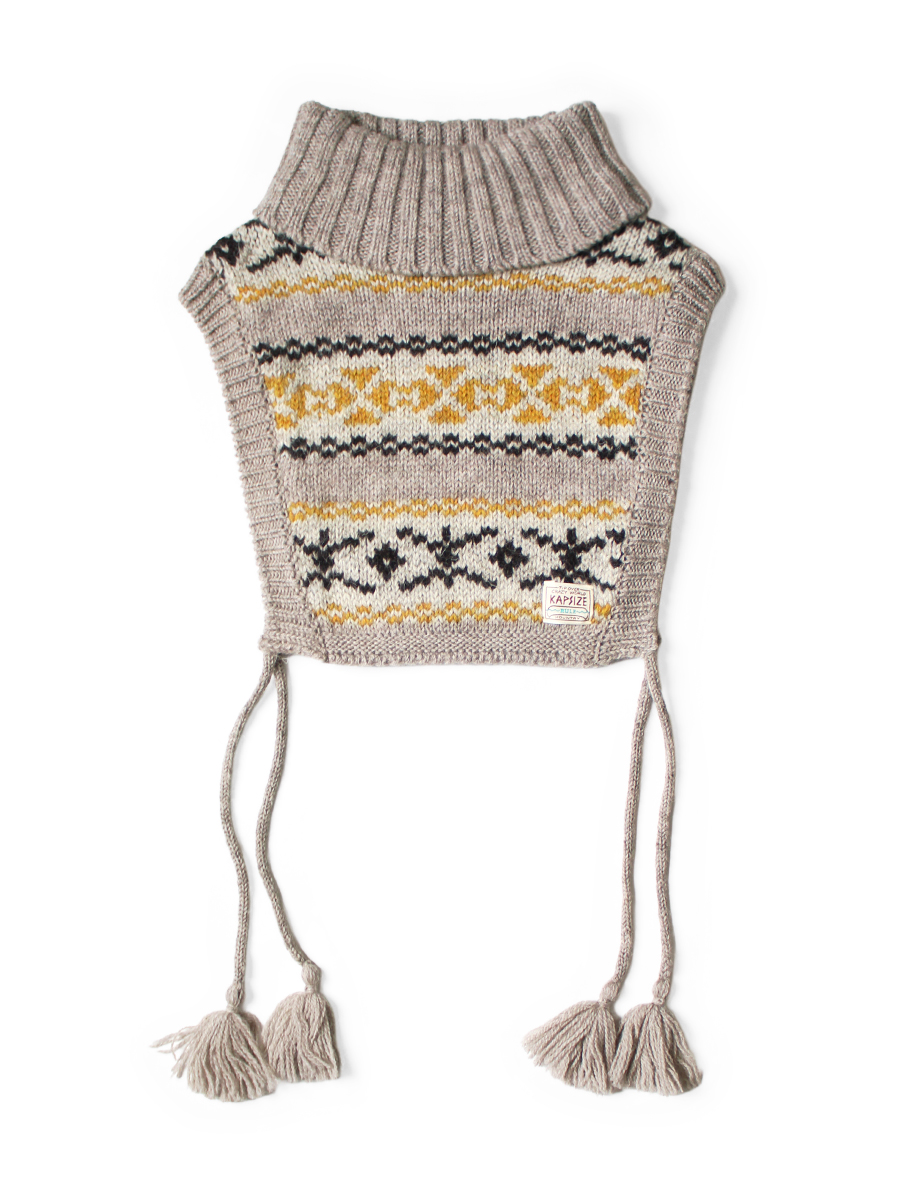 High-neck bib poncho with Fair Isle pattern, ribbed turtleneck collar, and hanging tassel cords displayed flat.