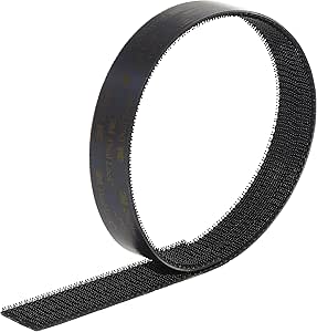 A roll of black 3M Dual Lock fastener tape showing the textured interlocking (hook and loop) surface.