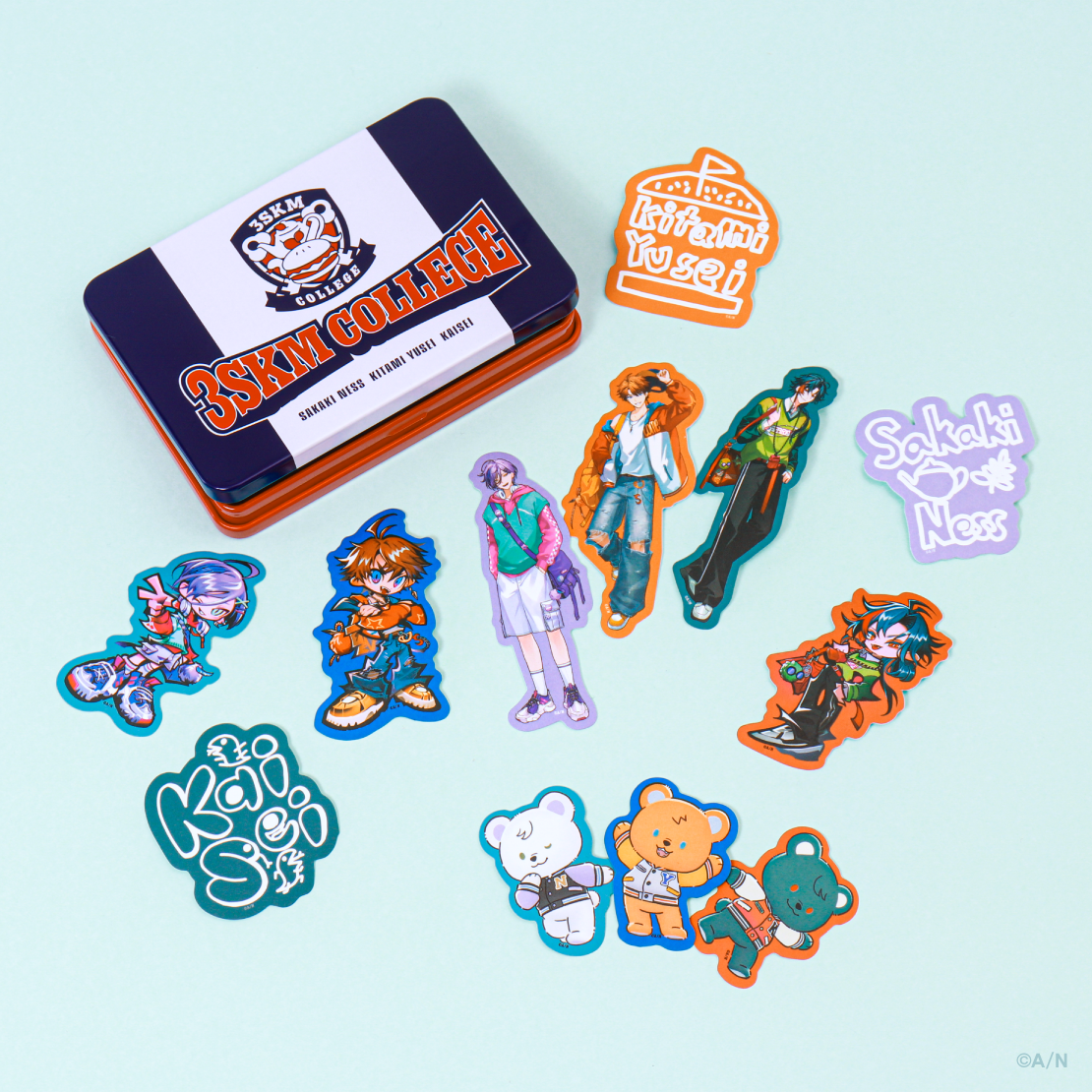 A tin case labeled "3SKM COLLEGE" with multiple character and bear stickers spread around it.