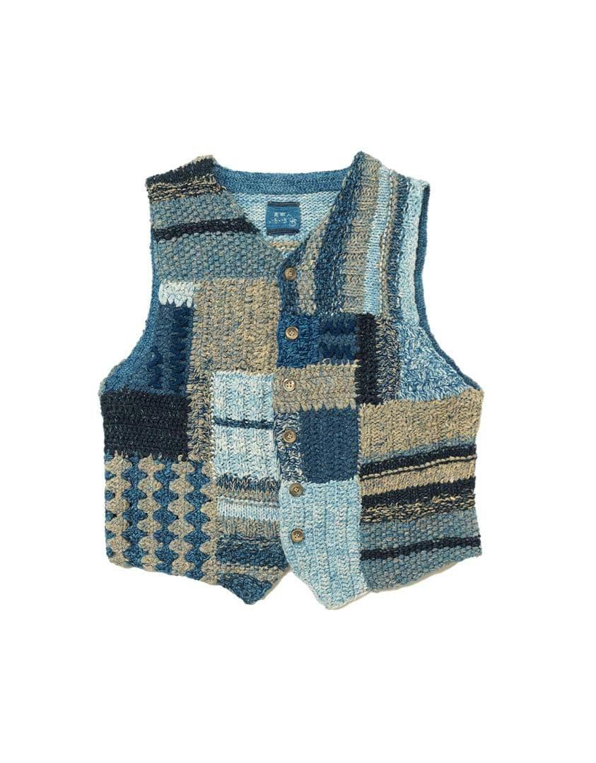Knitted wool vest with blue and beige patchwork panels and front buttons.