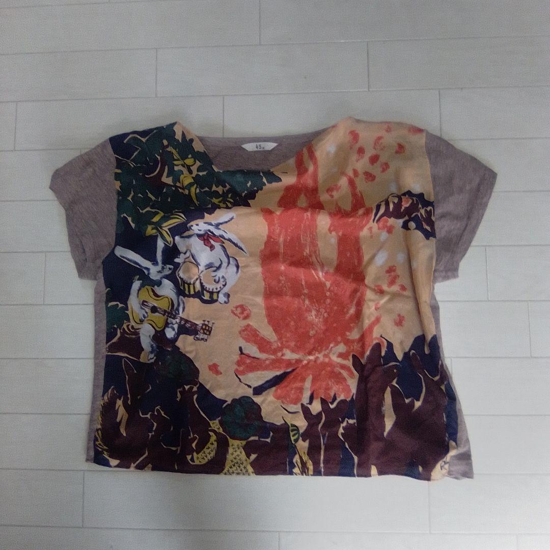 Flat-lay silk men's short-sleeve shirt with a colorful printed front panel and gray sleeves.