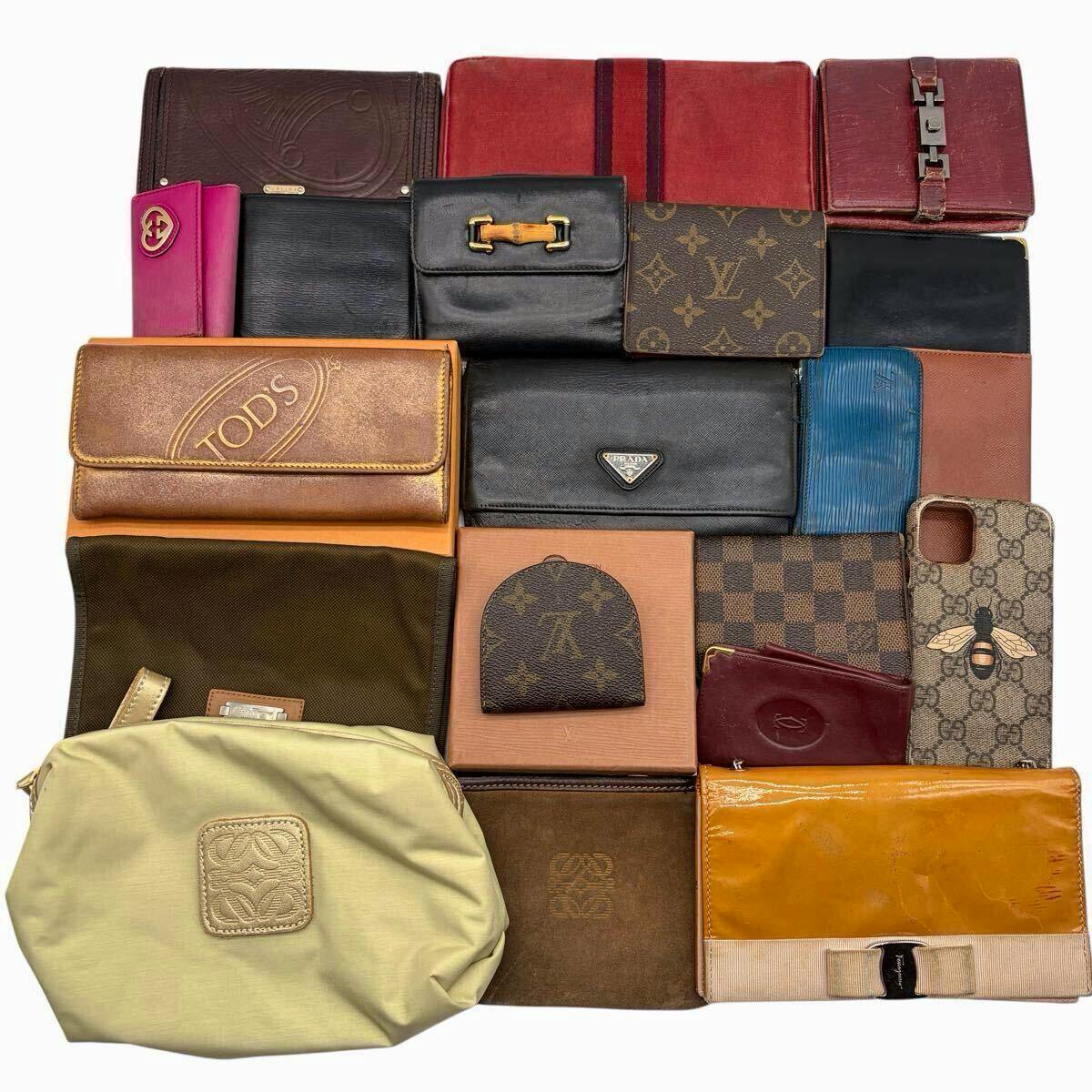 Flat lay of assorted wallets and small leather goods arranged on a white background, showing various patterns and colors.