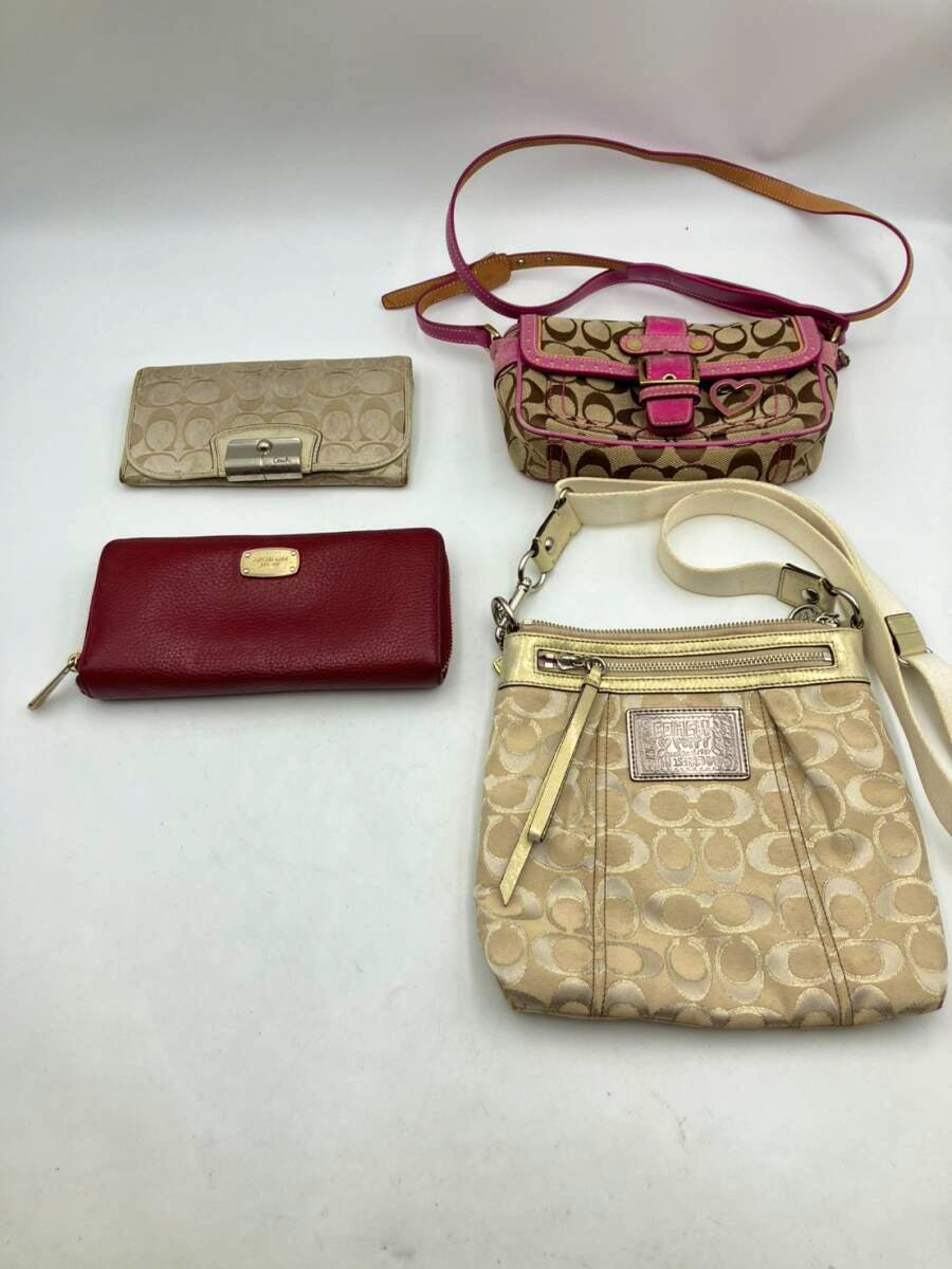 Four used women's bags and wallets (Coach and Michael Kors) arranged on a white background, including two small crossbody bags and two wallets.