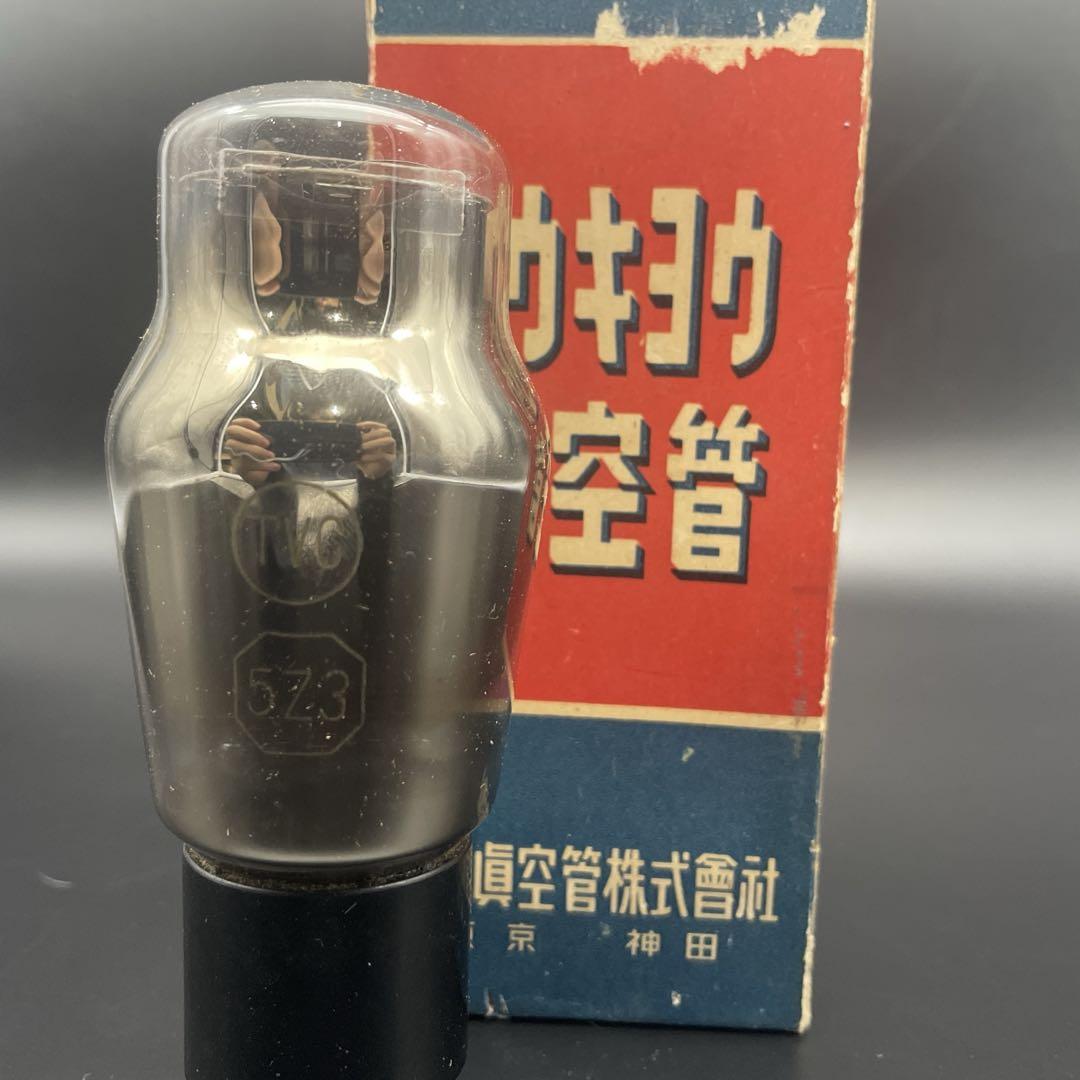 A 5Z3 vacuum tube with TVC marking standing upright in front of a red and blue product box.