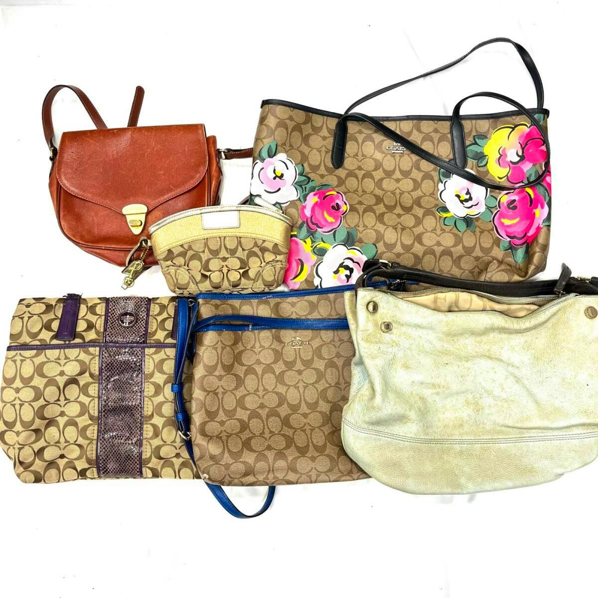 Bulk set of assorted handbags and pouches, including Coach monogram tote with floral print and other bags, arranged on a white background.