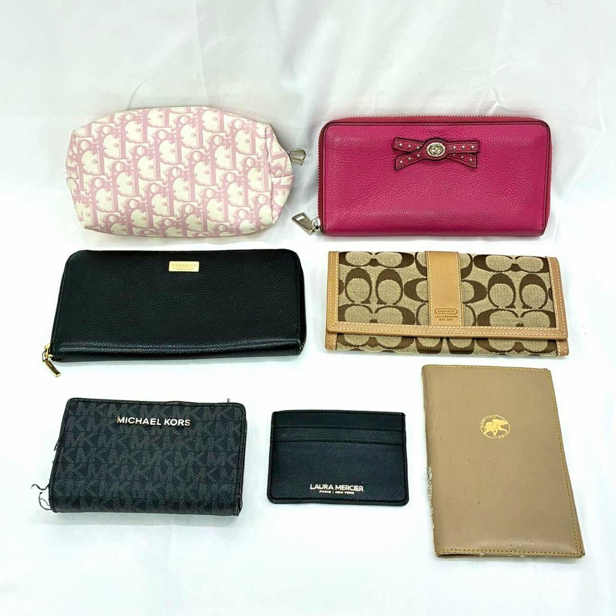 Seven wallets and card cases of various brands arranged on a white background.