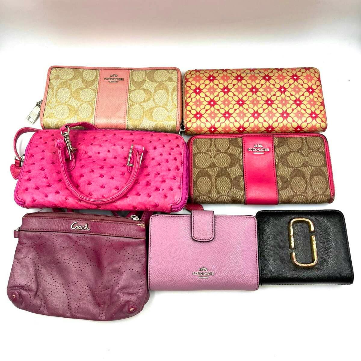 Seven wallets and small bags, including Coach designs, arranged on a white background.