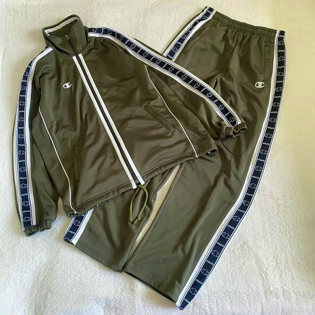 Khaki Champion 90s track jacket and matching track pants laid flat, showing logo tape along the sleeves and pant legs.