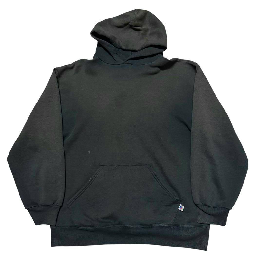 Front view of the faded 90s Russell Athletic ink-black hoodie showing the hood and kangaroo pocket with a small tag near the hem.