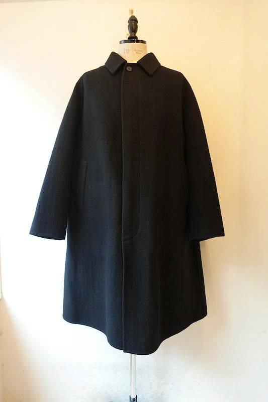 Front view of a black cashmere melton long women's coat displayed on a dress form.