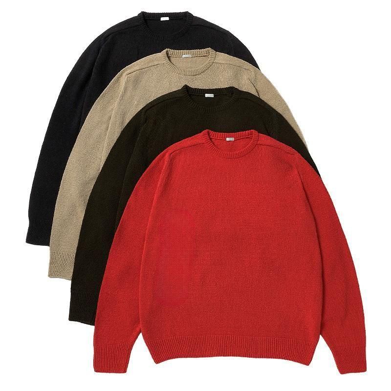 Four silk crewneck sweaters in red, dark green, beige, and black arranged overlapping on a white background.